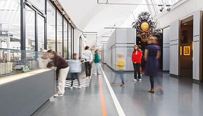 Personen (Erwachsene und Kinder) sehen sich die Ausstellung im Staatlichen Textil- und Industriemuseum Augsburg an.